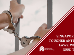 Hands in handcuffs behind bars